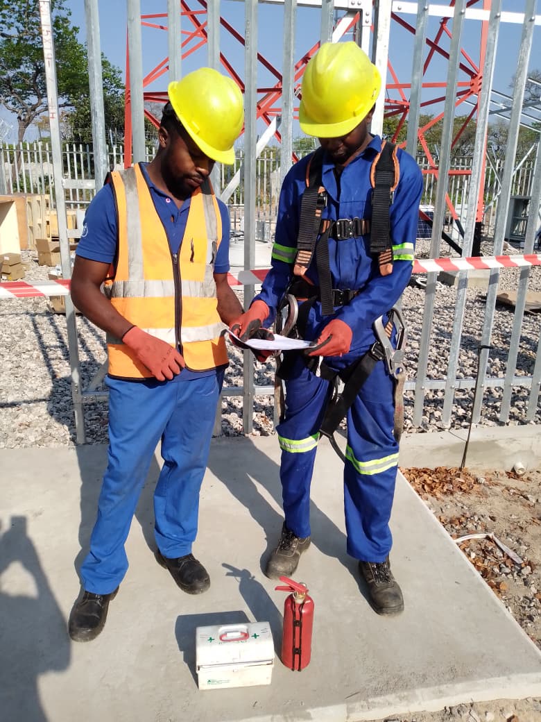 NSL engineers in PPE reviewing field documentation